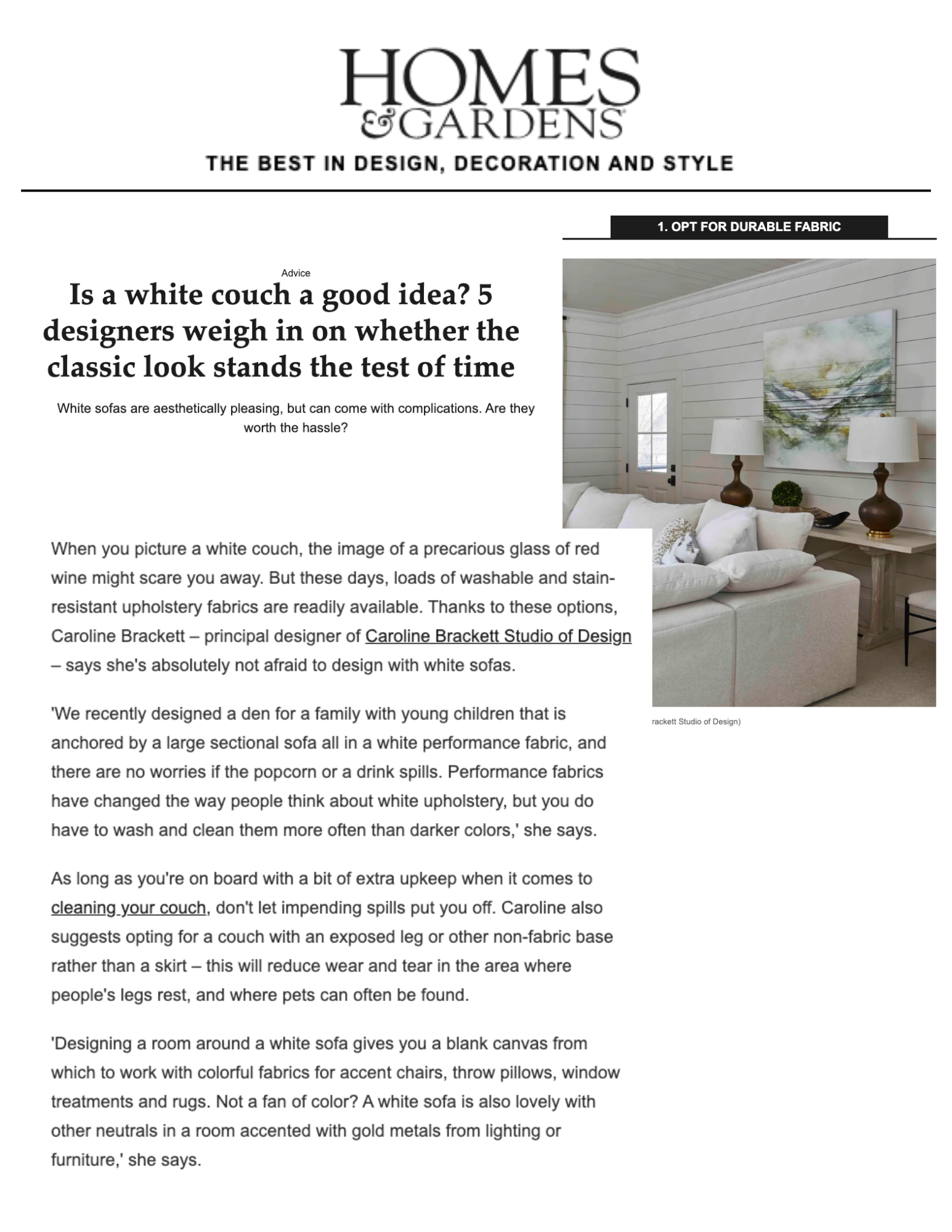 A page from Homes & Gardens magazine discussing designing with white sofas, featuring a photo of a living room with a white sofa, white paneled walls, a window, a large painting, two table lamps, and decorative pillows.